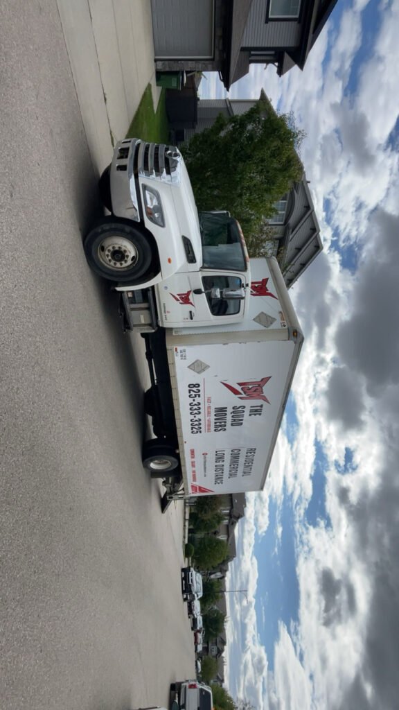 The Squad Movers moving truck on a residential street in the Edmonton area